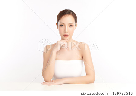 A beautiful young Asian woman with clean, fresh skin against a white background. Skincare, facial treatment, cosmetology, beauty, and spa. An elegant portrait of an Asian woman. A beautiful young Asian woman with clean, fresh skin against a white background. Skincare, facial treatment, cosmetology, beauty, and spa. An elegant portrait of an Asian woman. 139783516