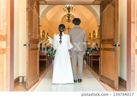 新娘和新郎走過婚禮大廳、教堂或教堂的背影(入口、婚禮、亞洲) 新娘和新郎走過婚禮大廳、教堂或教堂的背影(入口、婚禮、亞洲) 139784017
