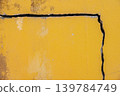 Full frame shot of cracked yellow wall. Wider cracks often represent serious structural damage and can cause serious issues. 139784749
