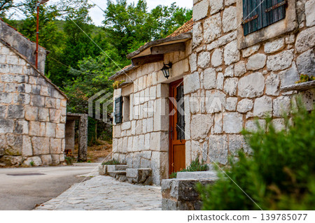 A Croatian mountain village landscape with rows of stone houses. 139785077