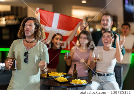 Group of fans in bar with Danish flag Group of fans in bar with Danish flag 139785331