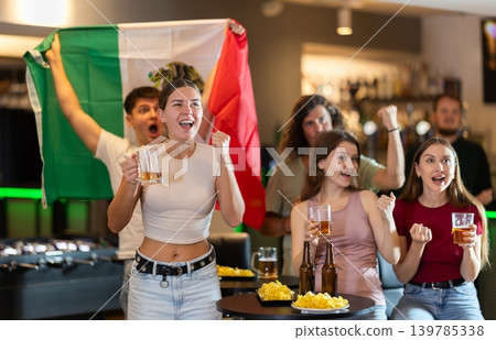 Group of friends cheer together for their favorite Mexican team in beer bar Group of friends cheer together for their favorite Mexican team in beer bar 139785338