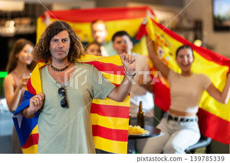 Group of fans in bar with flags of Catalonia and Spain Group of fans in bar with flags of Catalonia and Spain 139785339