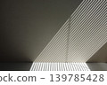 A striped background of light and shadow from blinds projected onto the wall and floor. 139785428