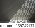 Striped background of light and shadow from blinds projected onto the wall. 139785433