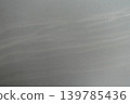 A smooth gray wall background with soft light filtering in. 139785436