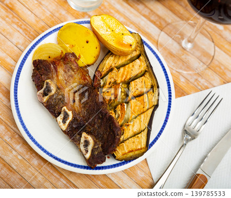 Grilled beef ribs with baked potatoes, eggplant and onion Grilled beef ribs with baked potatoes, eggplant and onion 139785533
