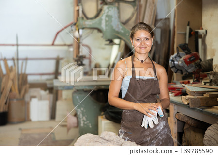 Young girl posing in taller workshop Young girl posing in taller workshop 139785590