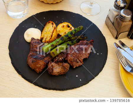 Grilled meat with arugula and potatoes 139785616