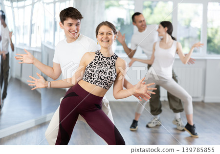 Couples of young men and women dancing twist Couples of young men and women dancing twist 139785855