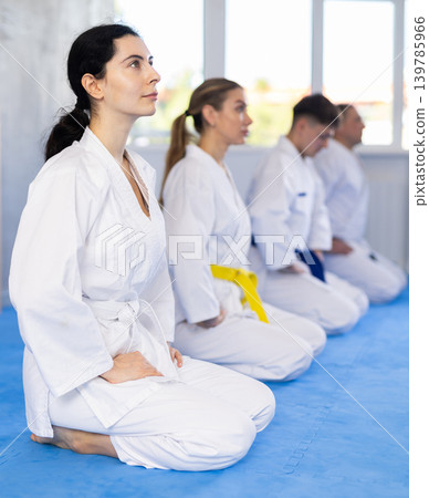 Group of male and female karatekas posing in studio Group of male and female karatekas posing in studio 139785966