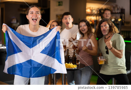 Group of fans in bar with Scottish flag Group of fans in bar with Scottish flag 139785985