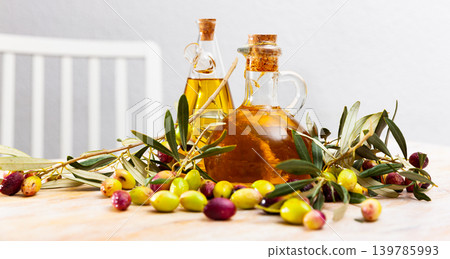 Olive oil in bottles on wooden table Olive oil in bottles on wooden table 139785993