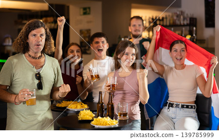 Fans of the Netherlands national team spend time in bar, shouting chants, supporting their favorite team Fans of the Netherlands national team spend time in bar, shouting chants, supporting their favorite team 139785999