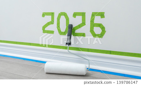 Wall painting project featuring green tape with the number 2026 and a paint roller on a wooden floor in a bright interior setting Wall painting project featuring green tape with the number 2026 and a paint roller on a wooden floor in a bright interior setting 139786147