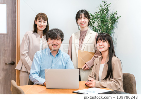 Businessmen, both male and female, having a meeting in a conference room. Businessmen, both male and female, having a meeting in a conference room. 139786248