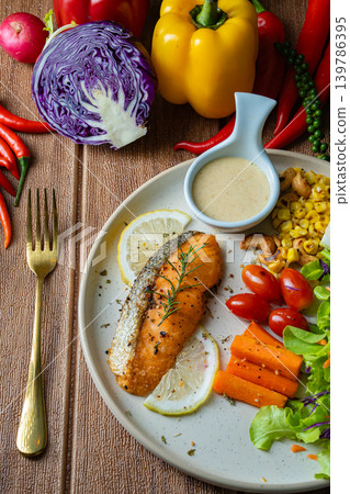 Grilled salmon fish fillet and fresh vegetable salad. Healthy food. Top view Grilled salmon fish fillet and fresh vegetable salad. Healthy food. Top view 139786395