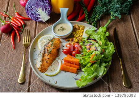 Grilled salmon fish fillet and fresh vegetable salad. Healthy food. Top view Grilled salmon fish fillet and fresh vegetable salad. Healthy food. Top view 139786398