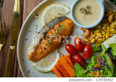 Grilled salmon fish fillet and fresh vegetable salad. Healthy food. Top view Grilled salmon fish fillet and fresh vegetable salad. Healthy food. Top view 139786402