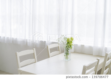 A dining table with a vase on it 139786477