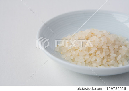 A close-up of 70% polished Tsuyahime rice in a dish. A close-up of 70% polished Tsuyahime rice in a dish. 139786626