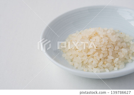 A close-up of 70% polished Tsuyahime rice in a dish. A close-up of 70% polished Tsuyahime rice in a dish. 139786627