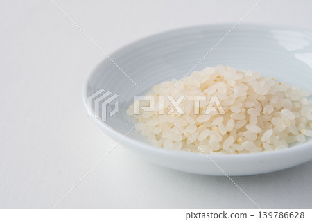 A close-up of 70% polished Tsuyahime rice in a dish. A close-up of 70% polished Tsuyahime rice in a dish. 139786628
