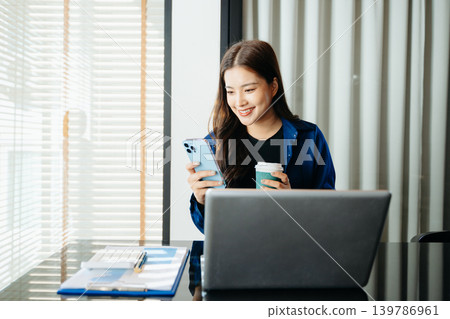 Business woman using tablet and laptop for doing math finance on an office desk, tax, report, accounting, statistics, and analytical research concept in office Business woman using tablet and laptop for doing math finance on an office desk, tax, report, accounting, statistics, and analytical research concept in office 139786961