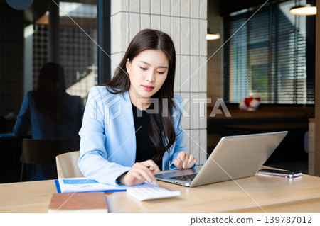 Business woman using tablet and laptop for doing math finance on an office desk, tax, report, accounting, statistics, and analytical research concept Business woman using tablet and laptop for doing math finance on an office desk, tax, report, accounting, statistics, and analytical research concept 139787012