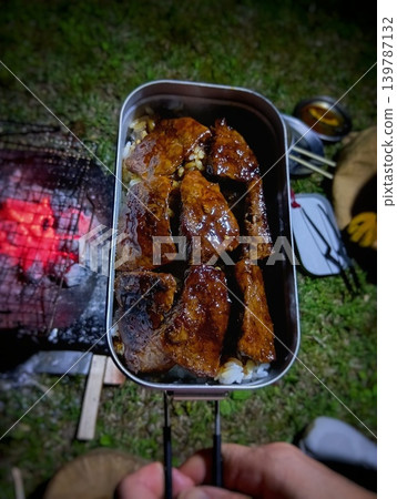A hearty steak bowl made in a mess tin on a camping night. A hearty steak bowl made in a mess tin on a camping night. 139787132