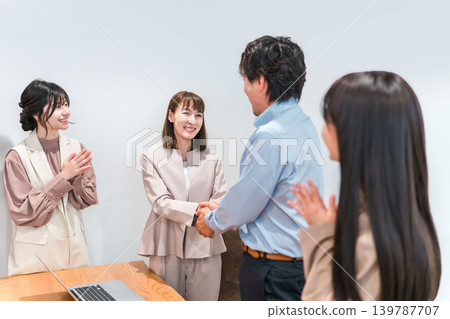 Businesswomen shake hands, introduce themselves, and sign contracts in a company office. Businesswomen shake hands, introduce themselves, and sign contracts in a company office. 139787707