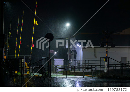 A railway crossing on a rainy night. A railway crossing on a rainy night. 139788172