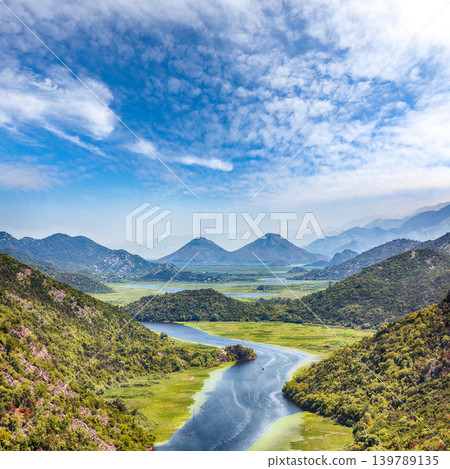 Amazing view of the Crnojevic river bend around green mountain peaks on a sunny day. Amazing view of the Crnojevic river bend around green mountain peaks on a sunny day. 139789135