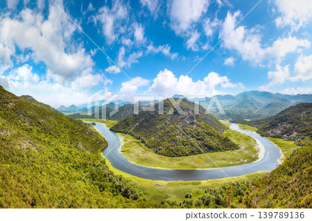 Amazing view of the Crnojevic river bend around green mountain peaks on a sunny day. Amazing view of the Crnojevic river bend around green mountain peaks on a sunny day. 139789136