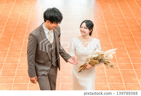 新娘和新郎在婚禮上爬上教堂的階梯(伴娘、新娘、婚禮、招待會) 新娘和新郎在婚禮上爬上教堂的階梯(伴娘、新娘、婚禮、招待會) 139789308