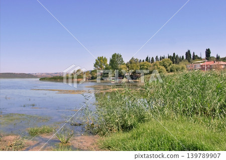 Golyazi Lakeside Village Bursa,Turkiye. Serene view of Golyazi on Uluabat Lake, Bursa, Turkey. Golyazi Lakeside Village Bursa,Turkiye. Serene view of Golyazi on Uluabat Lake, Bursa, Turkey. 139789907