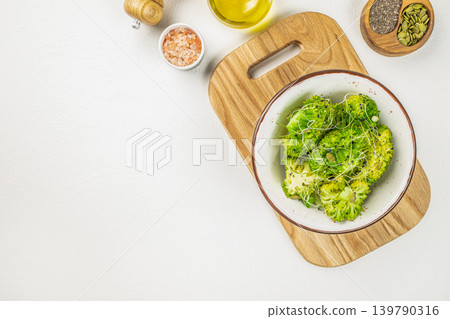 Broccoli salad bowl with microgreens and seeds on white background top view Broccoli salad bowl with microgreens and seeds on white background top view 139790316