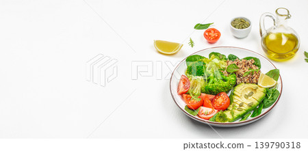 Healthy quinoa salad bowl with avocado broccoli and tomatoes on white background 139790318