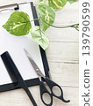 Hair salon consultations, menus, binders, and hair cutting scissors and combs. 139790599