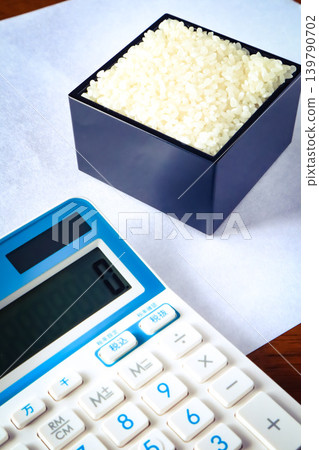 Rice in a measuring box and a calculator Rice in a measuring box and a calculator 139790702