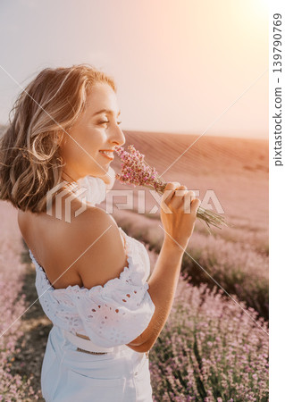Lavender woman field enjoying the aroma of a flower bouquet in a blooming purple meadow at sunset with copy space Lavender woman field enjoying the aroma of a flower bouquet in a blooming purple meadow at sunset with copy space 139790769