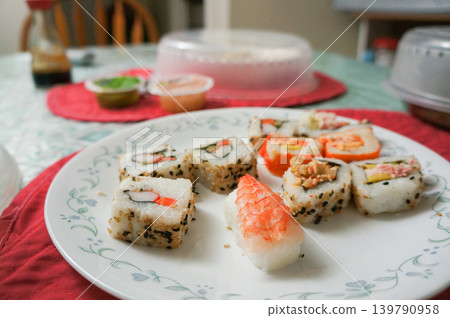 A variety of sushi platters served on the dining table at home A variety of sushi platters served on the dining table at home 139790958