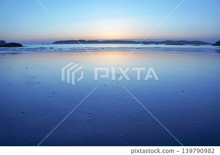 The tranquil seaside at dusk, bathed in a blue glow. The tranquil seaside at dusk, bathed in a blue glow. 139790982