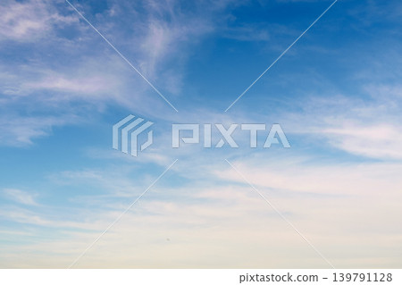 Pale clouds drift across the still-blue sky of the morning glow. Pale clouds drift across the still-blue sky of the morning glow. 139791128