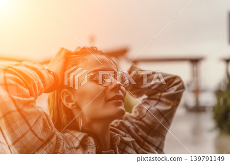 Woman rain glasses young female enjoying raindrops on her spectacles during sunset with hands on head and copy space Woman rain glasses young female enjoying raindrops on her spectacles during sunset with hands on head and copy space 139791149