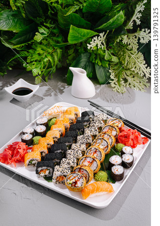 Sushi platter with various rolls and sides served on a white plate Sushi platter with various rolls and sides served on a white plate 139791325