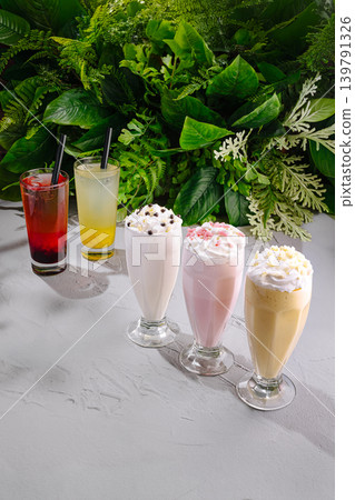 Refreshing drinks in glasses displayed with green plants in the background Refreshing drinks in glasses displayed with green plants in the background 139791326