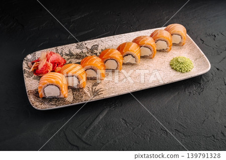 Fresh sushi rolls served on a decorative plate with wasabi and ginger 139791328