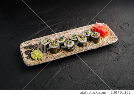 Sushi served on a plate with wasabi and pickled ginger in a restaurant Sushi served on a plate with wasabi and pickled ginger in a restaurant 139791331