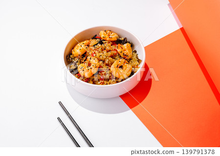 Shrimp fried rice served in a bowl on a white table with colorful background Shrimp fried rice served in a bowl on a white table with colorful background 139791378